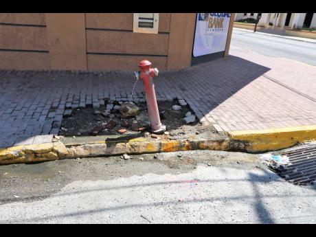 A steady flow of water has been running from this fire hydrant located in front of the First Global Bank at the intersection of Duke and Harbour streets in downtown Kingston.  The National Water Commission has implemented water restrictions for Kingston and St Andrew in light of falling inflow levels in the Mona Reservoir and Hermitage Dam.