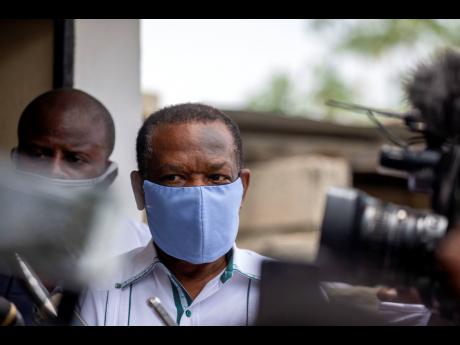 FILE – Yves Jean-Bart, president of the Haitian Football Federation, wearing a protective face mask, arrives for a court hearing regarding allegations that he abused female athletes at the country’s national training centre, in Croix-des-Bouquets, Haiti, May 21, 2020. Haiti’s former football federation president, whose lifetime ban from sport over sexual abuse allegations was overturned in February, announced yesterday that he is reclaiming his position.