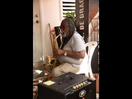 Veteran saxophonist Dean Fraser plays at the Dragon Be The One Reasoning Session in Cassia Park, St Andrew, on Thursday.