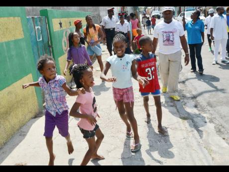 Children join in a peace march in west Kingston.