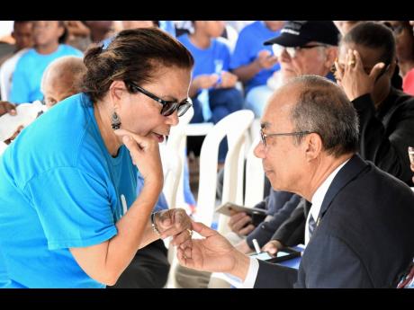 Janilee Abrikian (left), general manager of Peace and Love in Society (PALS), chats with Dr Horace Chang, minister of national security. 