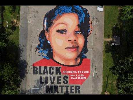FILE – A ground mural depicting a portrait of Breonna Taylor is seen at Chambers Park in Annapolis, Maryland, in 2020. 