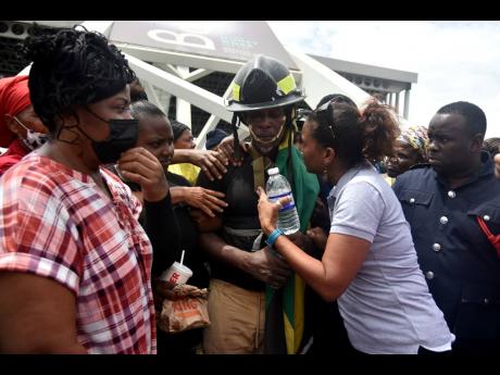Psychiatry Resident at the University Hospital of the West Indies Dr Saphire Longmore (second right) speaks with Bennett after his descent.