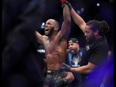 Leon Edwards celebrates his victory over Kamaru Usman in the the welterweight title bout at the UFC 286 mixed martial arts event on Saturday. 
