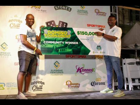 Credit: Contributed Dwayne Tulloch (right), SVP of Retail and Customer Operations, presents the winning cheque to Garfield Brissett (left) at the Supreme Domino Master Series held at Maggie’s Sports Bar on the weekend.