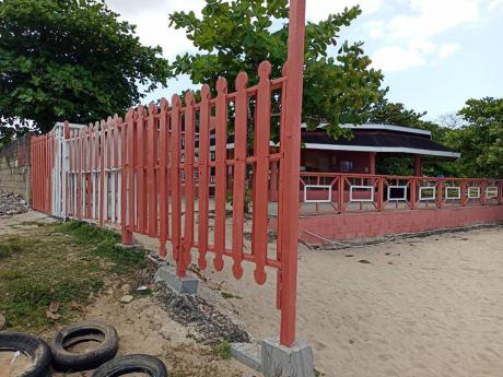 The picket fence through which gunmen fired on the wedding party at Shields resort in Negril, Westmoreland on Saturday.