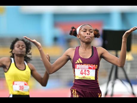 Holmwood Technical’s Jody Ann Mitchell celebrates winning the Class One girls’ 1500 metres in a record time of 4:29.42.