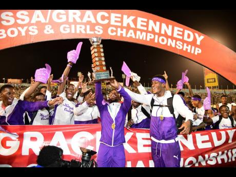 Kingston College’s co-captains Bouwahjgie Nkrumie (foreground left) and Yourie Lawrence Clarke heist the Mortimer Geddes Trophy as they celebrate their 34th ISSA/GraceKennedy Boys and Girls’ Athletics Championships title at the National Stadium on Saturday.
