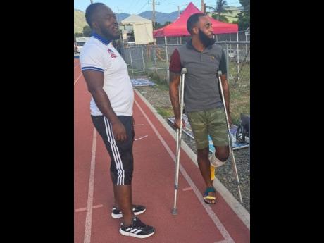 Fabian McCarthy (right) and Dunbeholden’s assistant coach Craig Richards after their 3-2 Jamaica Premier League (JPL) win over Molynes United at the Ashenheim Stadium on Sunday.