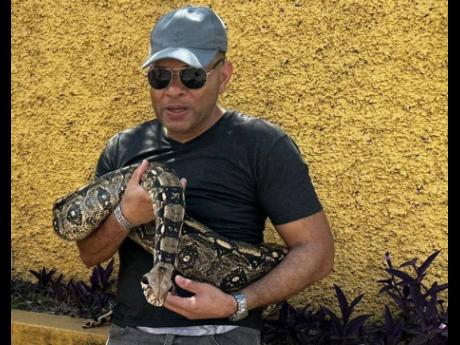 Mark Smellie poses with his pet snake, Yogi. 