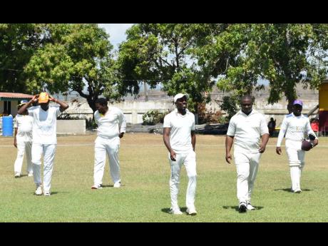 Members of Greater Portmore enter the Prison Oval field before dismissing Correctional Services for 113 in their Jamaica Energy Partners (JEP) St Catherine cricket league over the weekend.