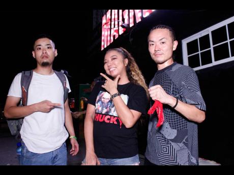 Bad Gyal Marie (centre) is flanked by Rispec Jam’s Shoya Gonda (left) and Kenji Mimura following their sound clash win on Friday.
