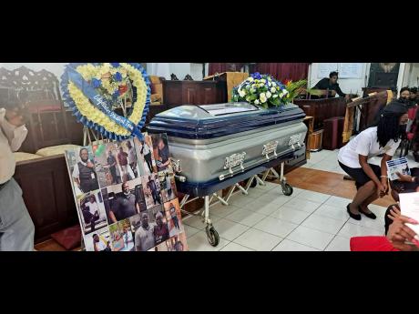The coffin bearing the remains of Lawrence ‘Mark’ McKenzie, who was killed by armed men who attacked him and two other Beryllium colleagues as they attempted to service an ATM in  Portmore, St Catherine on February 27. 