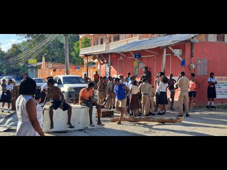 Protesting residents of Fairy Hill, Portland, blocked the roadway yesterday to bring attention to their plight. 