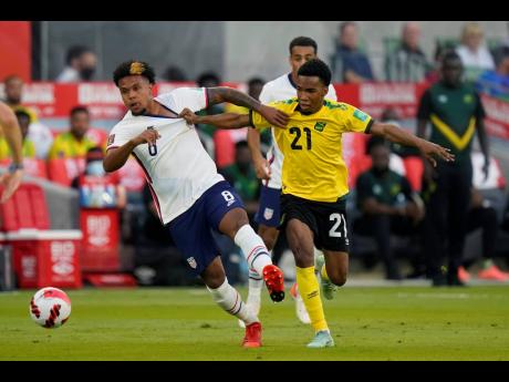 Jamaica’s Tyreek Magee (right) battles with United States’ Weston McKennie  during a FIFA World Cup qualifying match on Thursday, October 7, 2021, in Austin, Texas.