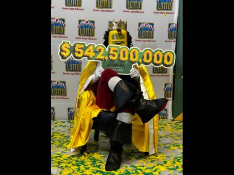 Super Lotto winner A. Fraser sits in the money seat showing off his history-making win. 