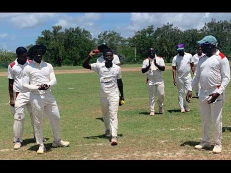 St Jago High schoolboy, left-arm spinner Vitel Lawes (ball in hand), leaves the field with teammates after taking five wickets for Phoenix Park in their match against Old Harbour at Port Esquivel in the JEP 40-over league on the weekend.