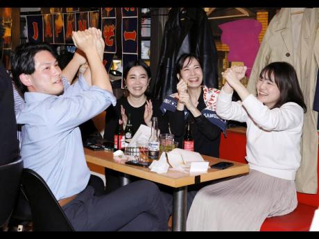 Credit: AP Japanese supporters react to Team Japan scoring in a World Baseball Classic game.