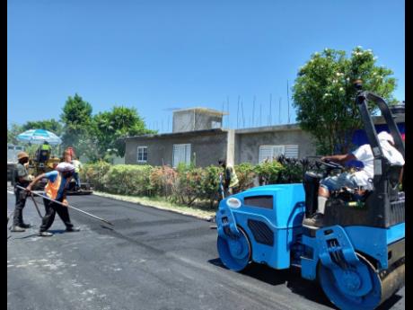 Credit: Contributed Workmen pave Garden Crescent in St James. The roadway is one of 12 roads currently being rehabilitated by the National Works Agency through the Government of Jamaica’s Islandwide Repair to Scoured and Damaged Roads Programme.