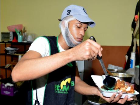 Social media cooking sensation Rameish DeSouza preparing lunches at his newly opened restaurant Rameish Kitchen in downtown Kingston.
