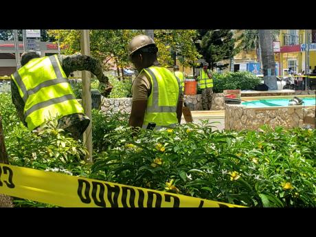 Jamaica Defence Force soldiers setting the base for the Usain Bolt statue in Water Square, Falmouth, Trelawny.