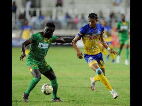 Harbour View’s Garth Stewart (right) prepares to challenge Humble Lion’s Ricardo Campbell during their Jamaica Premier League quarter-final match at Sabina Park last Monday. Harbour View will take a 2-0 win from that match into today’s second-leg encounter.