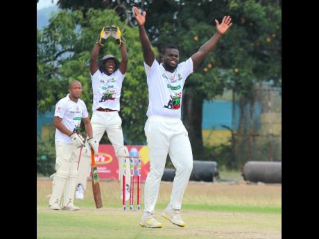 National left-arm spinner Jeavor Royal (right) of Bushy Park/Church Pen successfully appeals for the wicket of Sean Parchment of Ewarton Slazenger during their Cal’s SDC Community Twenty20 (T20) encounter at Chedwin Park yesterday. Bushy Park/Church Pen won with a faster run rate.