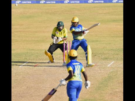 Barbados opener Aaliyah Alleyne plays a shot on her way to an unbeaten half-century against Jamaica Women in their third round T20 Blaze clash at Warner Park in St. Kitts yesterday. Wicketkeeper Natasha McLean looks on.