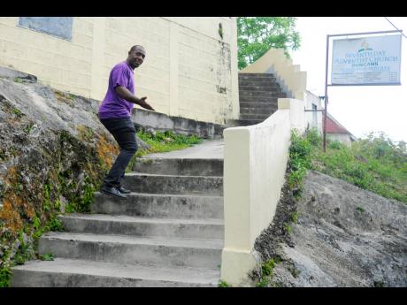 Paster Delroy Codner shows the steps which have been difficult for some members to climb.