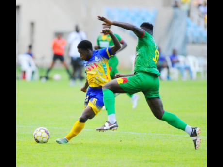 Cristojaye Daley (left) of Harbour View prepares to take a shot at goal as Ricardo Campbell of Humble Lion moves in to tackle during their Jamaica Premier League match at Sabina Park on May 22, 2023.