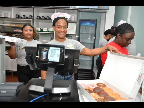 Krispy Kreme team members welcome guests to its Waterloo Road, St Andrew, store on Saturday.
