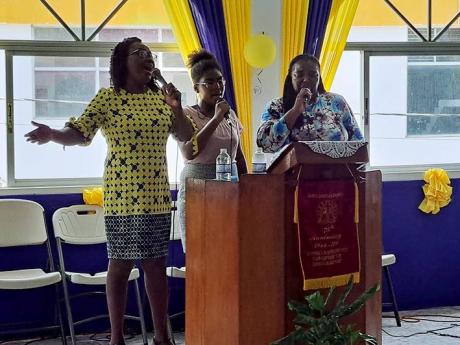 Sandra-Dean Moore (right), the widow of the late deputy commissioner of corrections Reverend Orville Moore, sings with the praise team at Santa Cruz Holiness Christian Church in St Elizabeth during service yesterday.