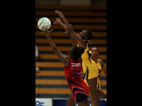Jamaica’s Crystal Plummer (right) in action against Cayman Island’s Deidrian Gardner during last year’s Americas Netball World Cup qualifiers at the National Indoor Sporting Centre.