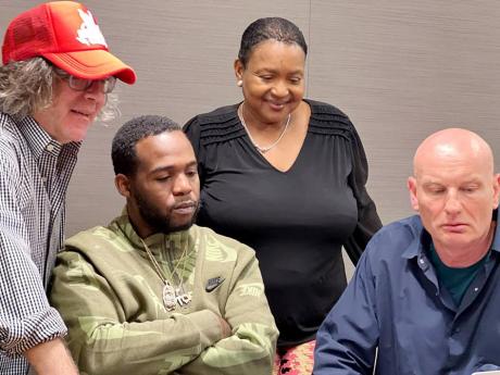 From left: Attorney Andrew Krents, Teejay, Sharon Burke and Warner’s Guy Moot at last week’s signing.