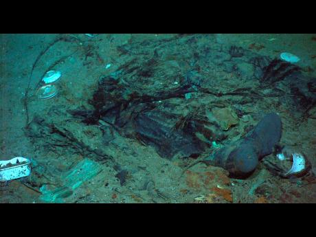 FILE - This 2004 photo provided by the Institute for Exploration, Center for Archaeological Oceanography/University of Rhode Island/NOAA Office of Ocean Exploration, shows the remains of a coat and boots in the mud on the sea bed near the Titanic’s stern. A search is under way for a missing submersible that carries people to view the wreckage, according to media reports. (Institute for Exploration, Center for Archaeological Oceanography/University of Rhode Island/NOAA Office of Ocean Exploration, File)