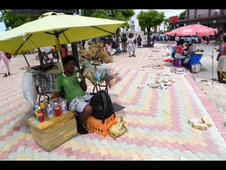 Vendors seek sales in South Parade, downtown Kingston. Bricks are being laid in sections of the area, adding to the aesthetic. 