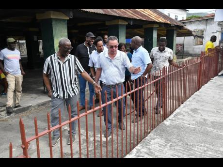 Minister of Local Government and Community Development, Desmond McKenzie (left), and Minister of Science, Energy, Telecommunications and Transport and Portland West Member of Parliament Daryl Vaz (right) tour the Buff Bay Market in Portland. The market is to be renovated to provide an upgraded facility for vendors to ply their wares. 