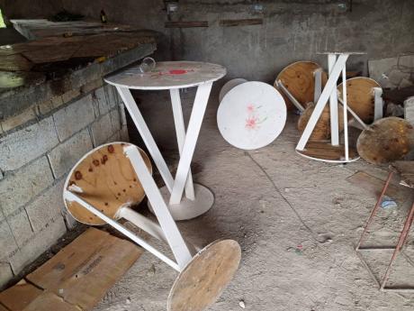 Overturned tables show the chaos that ensued after gunmen opened fire at patrons at a jerk centre in Bridgewater, Westmoreland, on Sunday, killing one man.