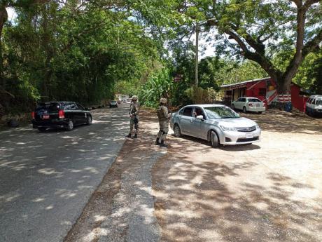 Members of the security forces manning a checkpoint in St James. The parish is currently under another state of public emergency.