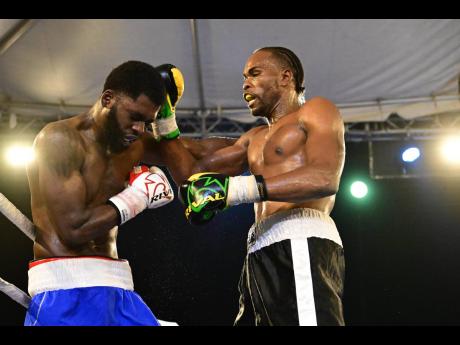 Jermaine ‘Breezy’ Richards (right) of I Fights Promotion lands a punch on opponent Stephen Kirnon of Bronx Boxing Gym in the heavyweight bout at the  Wray and Nephew Fight Nights held at Cling Cling Oval in St Andrew on Saturday. Richards scored a third-round technical knockout.