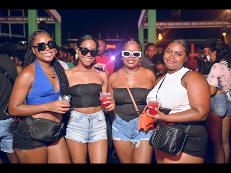 From left: Natalie Henry, Anelea Whyte and Sudeana Stewart paused  their enjoyment for a picture perfect moment at the Campari-sponsored Hard Wine soca party. 