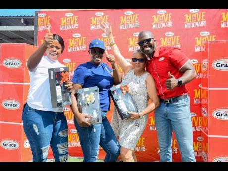 Newly-minted millionaire Simone Barker (second left) poses with the other top winners for June in the Grace Foods ‘Move Like a Millionaire’ promotion. Second-place winner Aliesha Swaby (left) won $500,000 while Patricia Gryff-Dickenson won a year’s supply of groceries. The winning women are joined by Grace Foods Regional Sales Manager – Eastern, Denver McDonald at the official handover of the prizes held on June 30 at the GraceKennedy head office in downtown Kingston.