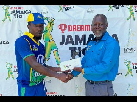 Middlesex United Stars batsman Suwayne Wilson (left) accepts his Man-of-the-Match award from Jamaica Cricket Association Cricket Operations and Development Manager, Oniel Cruickshank, after they defeated Middlesex Titans by nine wickets in the Dream XI sponsored Jamaica T10 competition at Kensington Park yesterday.