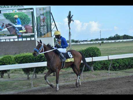 LEGIT BOSS (left), ridden by Tevin Foster, wins the Pick 3 Super Challenge Trophy at Caymanas Park in November last year.
