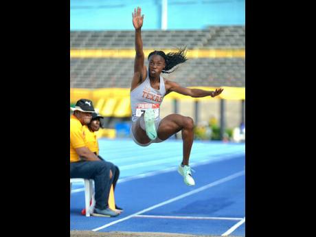 Ackelia Smith flies through the air in an effort that places her third in the women’s long jump at the National Senior and Junior Championships at the National Stadium on Thursday.