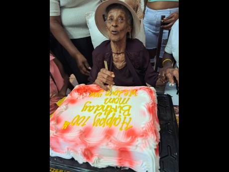 Credit: Rasbert Turner An excited Myrtle Dowe gets ready to cut her birthday cake.