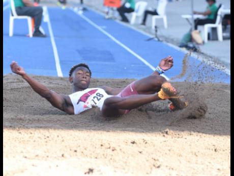 Jaydon Hibbert lands in the pit while competing in the men’s triple jump at the National Senior and Junior Championships at the National Stadium on Sunday. Hibbert leapt 17.68 metres to win the event.