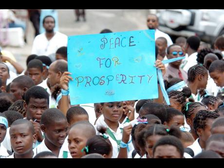 Students of both the New Day Primary and Junior High and Shortwood Practising Junior High schools participate in a peace march in Grants Pen. 