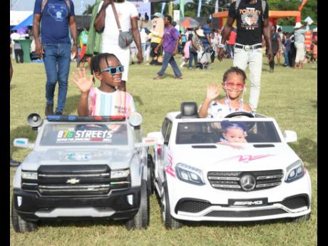 Alex Hudson and his sister, Xela, demonstrate their driving skills at yesterday’s fun day.