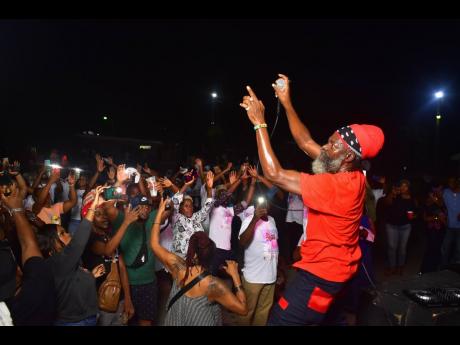 The ‘Fireman’ Capleton gets the crowd in a frenzy at the set-up for his late manager Claudette Kemp, which was held at the Police Officers’ Club, Hope Road, St Andrew on Monday.